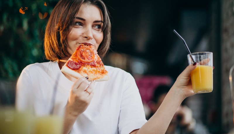 young-pretty-woman-eating-pizza-bar (1)